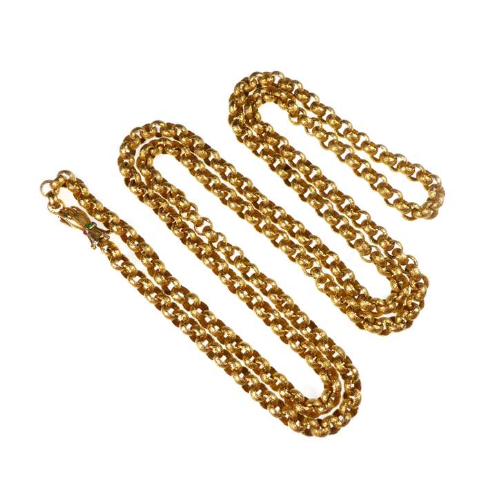 Gold long muff chain necklace on a hand clasp